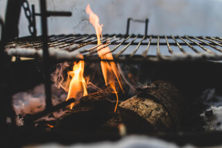 burning-under-black-metal-grill