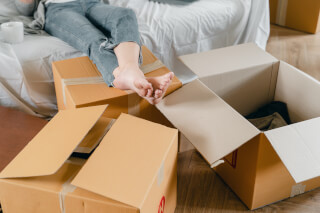 crop-unrecognizable-slim-woman-sitting-on-sofa-near