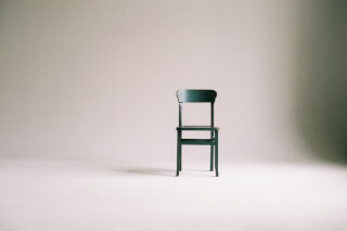 green-wooden-chair-on-white-surface