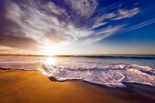 seashore-under-white-and-blue-sky-during-sunset