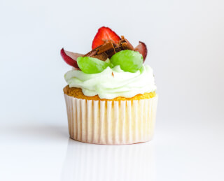 white-and-yellow-cupcake-with-fruit-toppings
