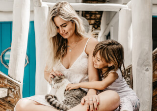 woman-and-child-sitting-while-holding-a-cat