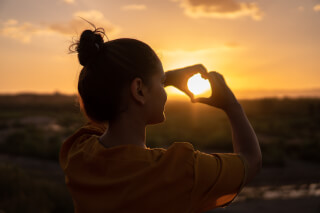 woman-doing-hand-heart-sign