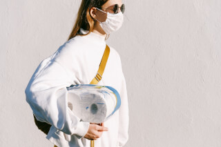 woman-in-mask-holding-toilet-paper