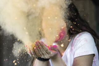 woman-in-white-cap-sleeved-shirt-blowing-dust