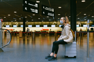 woman-sitting-on-luggage